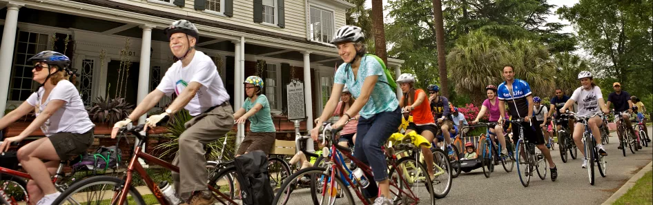 Large group of people cycling through downtown Columbia.